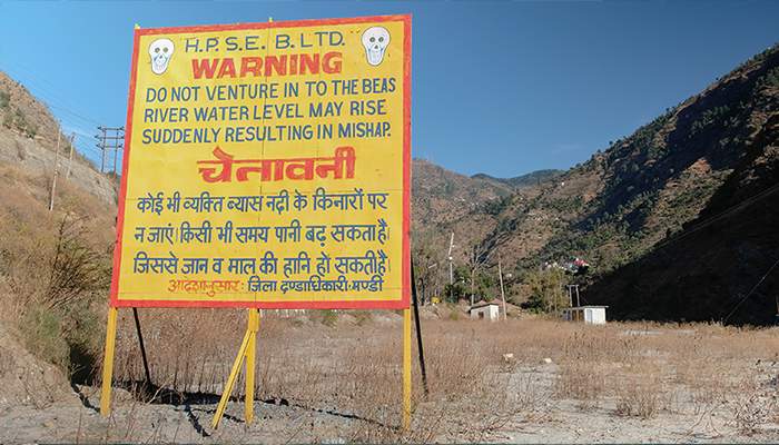 A warning signboard that has come up at the spot close to where 24 engineering students from Hyderabad got washed away in Beas River. The students were caught unawares when the water was suddenly released from the dam. Photo: Sriram V Murthy.